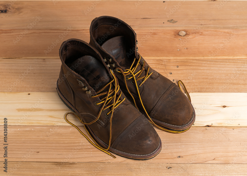 Safety working boots on wooden board construction concept.
Safety working boots on wooden board construction concept.