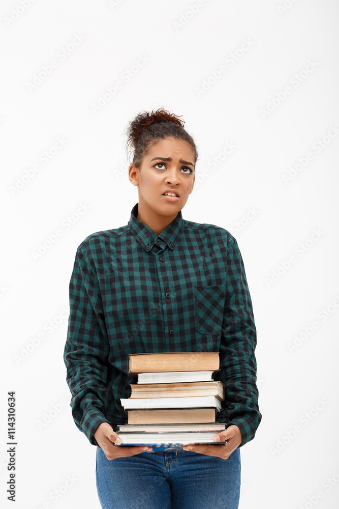 Portrait of young african girl with books over white background. Portrait of young african girl with books over white background.