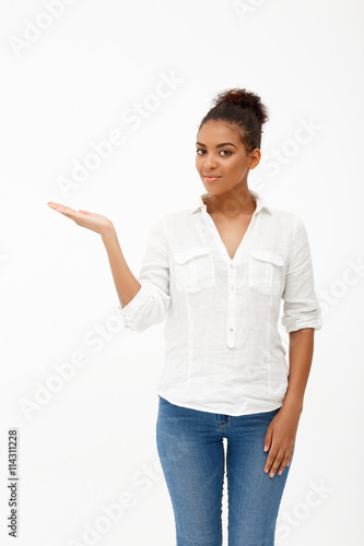 Portrait of young beautiful african girl over white background.