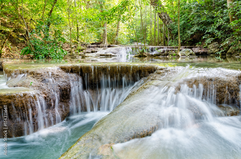 Fototapeta premium Beautiful waterfall and tropical forests at Erawan National Park is a famous tourist attraction in Kanchanaburi Province, Thailand