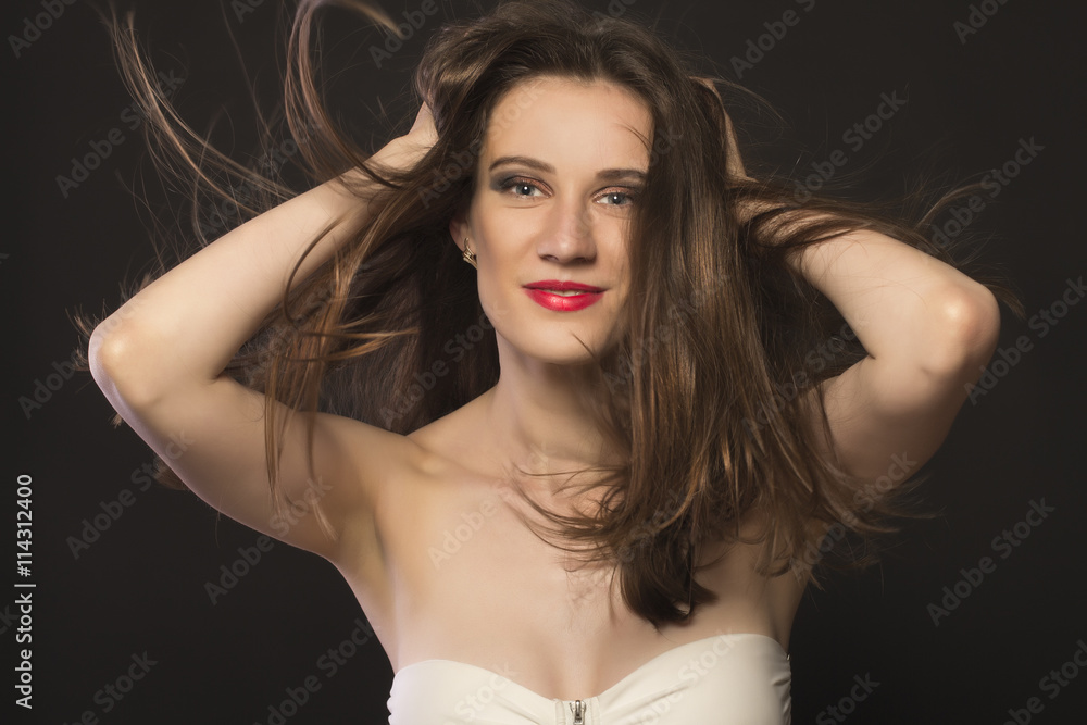 Woman with hair motion on black background closeup Woman with hair motion on black background closeup