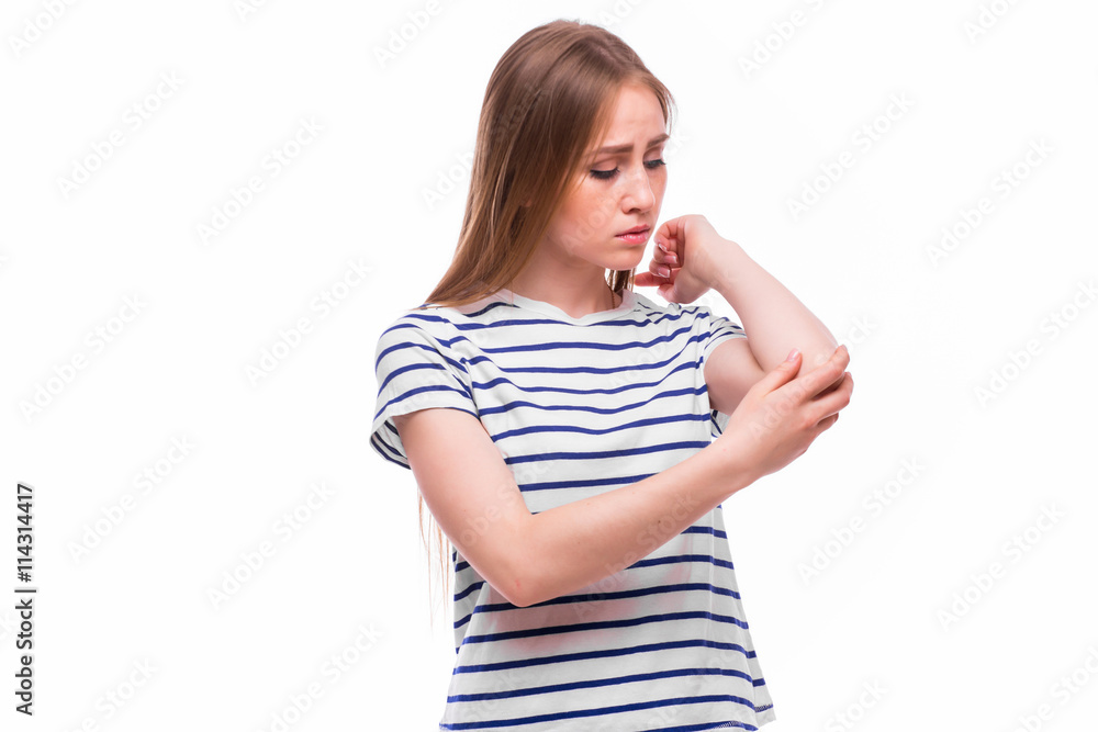 Acute pain in a woman elbow. Female is holding hand to spot of elbow pain indicating location of the pain. Isolation on a white background. Acute pain in a woman elbow. Female is holding hand to spot of elbow pain indicating location of the pain. Isolation on a white background.