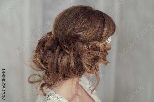 Studio portrait of beautiful bride with perfect hairstyle and ma