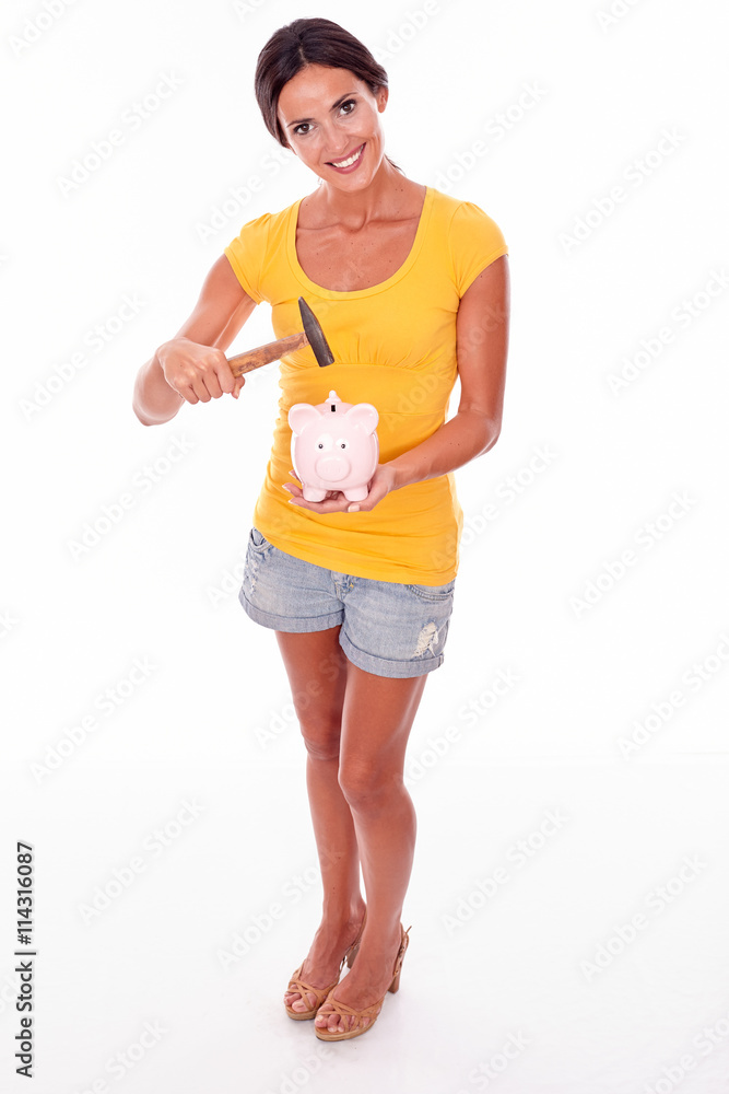 Smiling young brunette with piggy bank Smiling young brunette with piggy bank