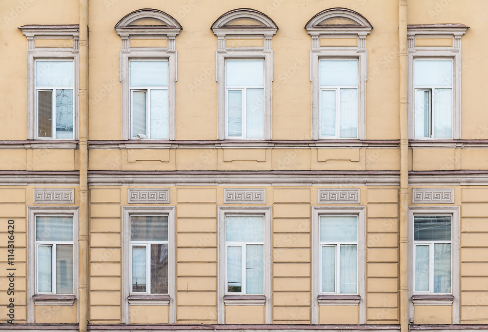 Several windows in a row on facade of urban office building front view, St. Petersburg, Russia.