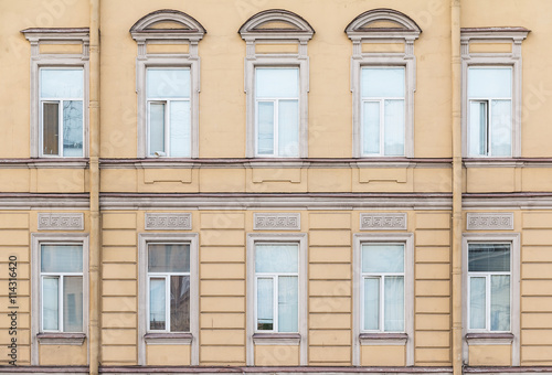 Several windows in a row on facade of urban office building front view, St. Petersburg, Russia.