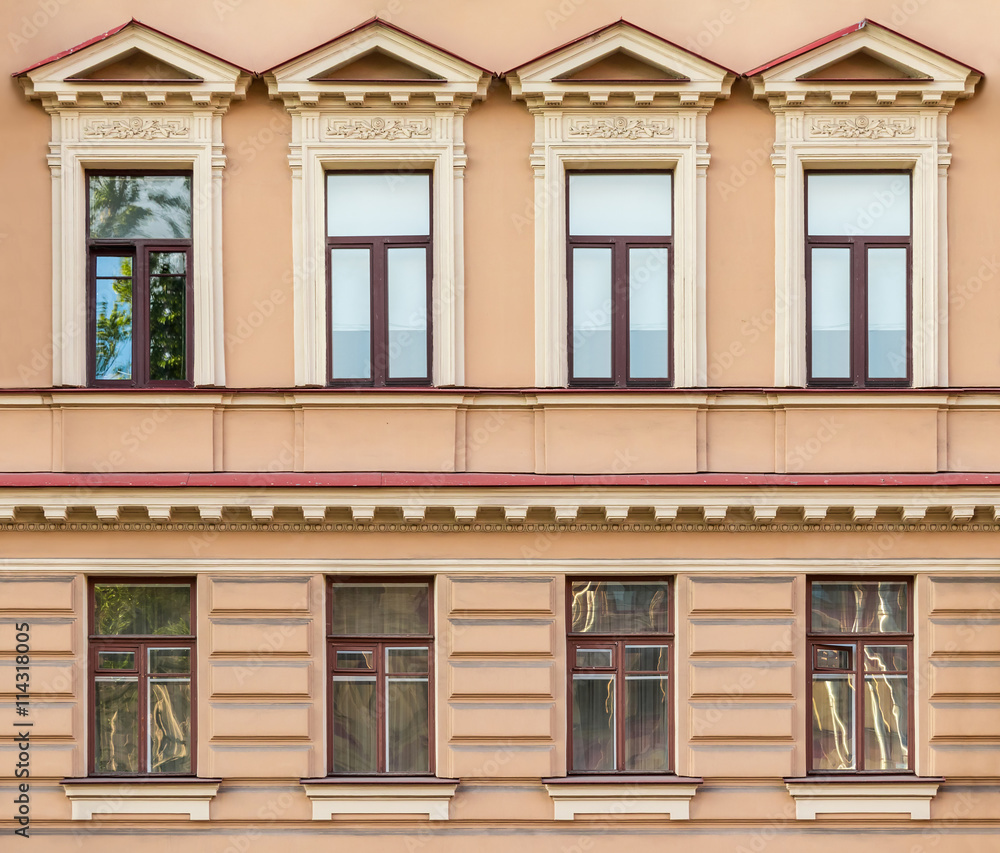 Several windows in a row on facade of urban apartment building front view, St. Petersburg, Russia. Several windows in a row on facade of urban apartment building front view, St. Petersburg, Russia.