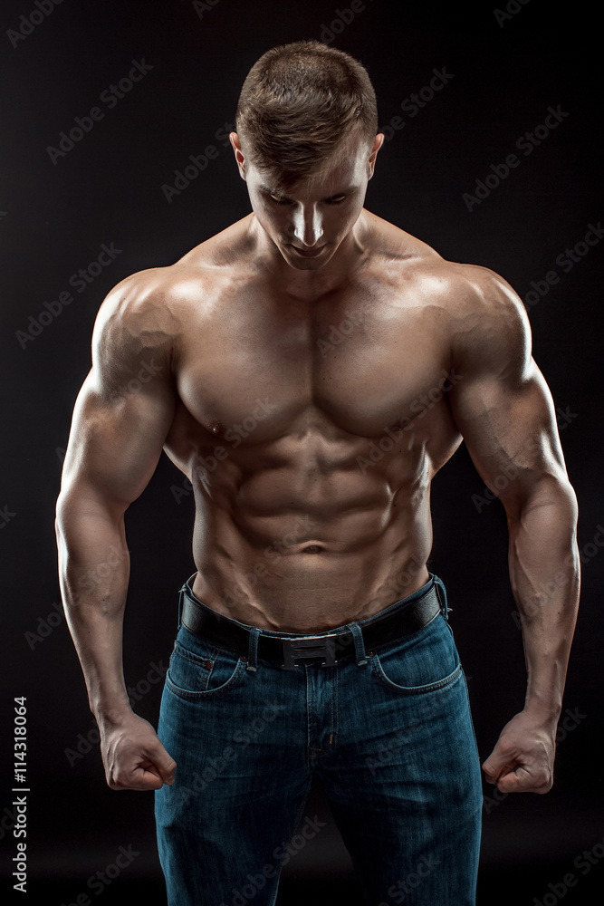 Muscular bodybuilder guy doing posing over black background Muscular bodybuilder guy doing posing over black background