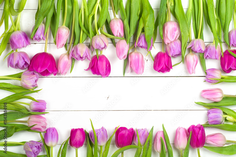 Bright, beautiful tulips on a wooden background. Top view. Copy space for text. card with flowers