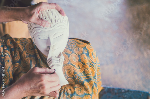 Copyrighted free image of unrecognize people sandpapering a wooden mask  part 3