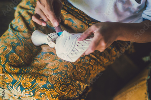 Copyrighted free image of unrecognize people sandpapering a wooden mask  part 2