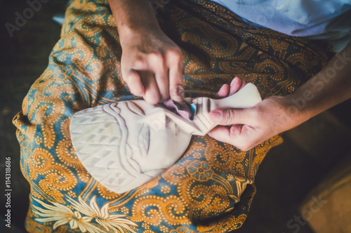 Copyrighted free image of unrecognize people sandpapering a wooden mask  part 1