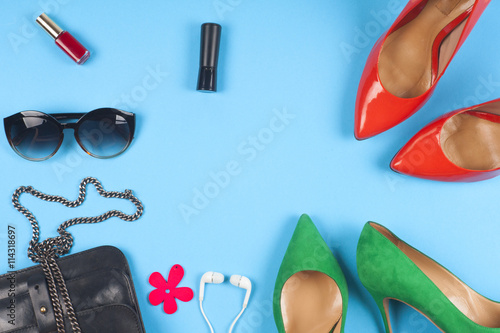 Women clothing set and accessories on light background.Top view, different shoes on light background. Copy space for text.