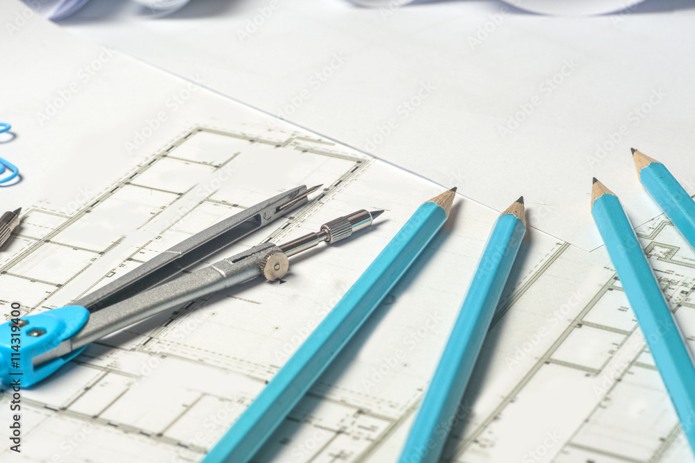 Workplace of architect - Architect rolls and plans. architectural plan,technical project drawing. Engineering tools view from the top. Construction background. Workplace of architect - Architect rolls and plans. architectural plan,technical project drawing. Engineering tools view from the top. Construction background.