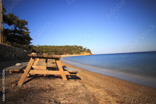 Single bench near the sea with long exposure image
