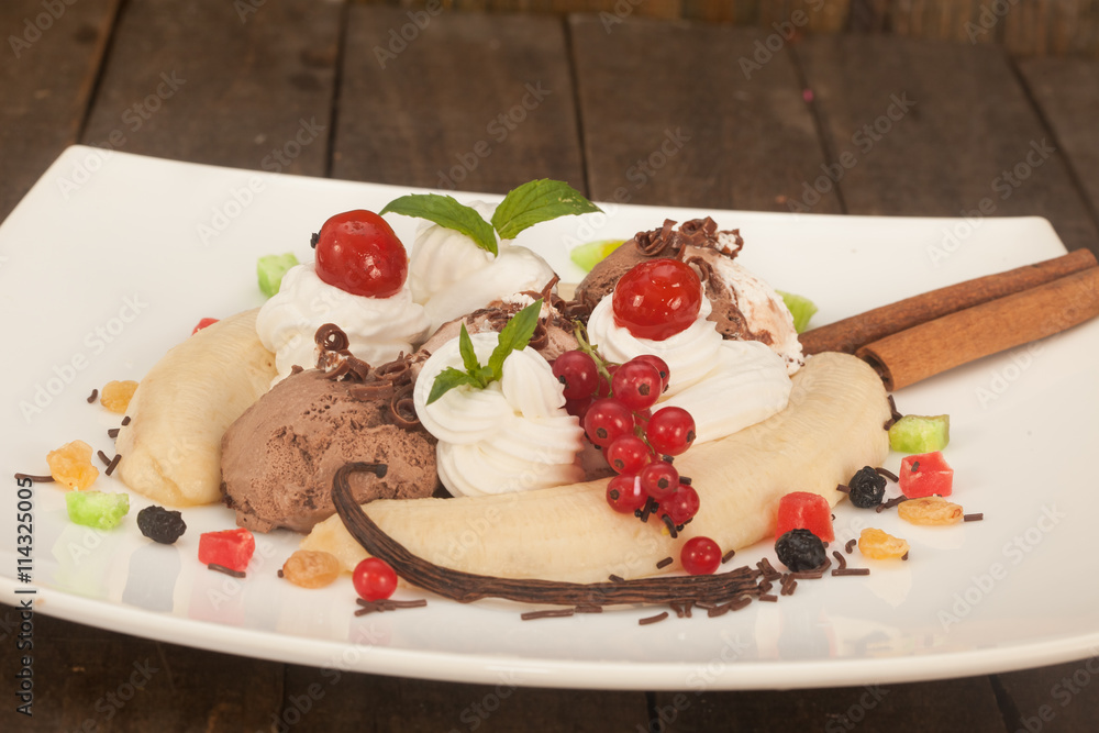 Ice cream sundae, Banana Split with topping, dry fruit, mint leaves and cherry. Ice cream sundae, Banana Split with topping, dry fruit, mint leaves and cherry.
