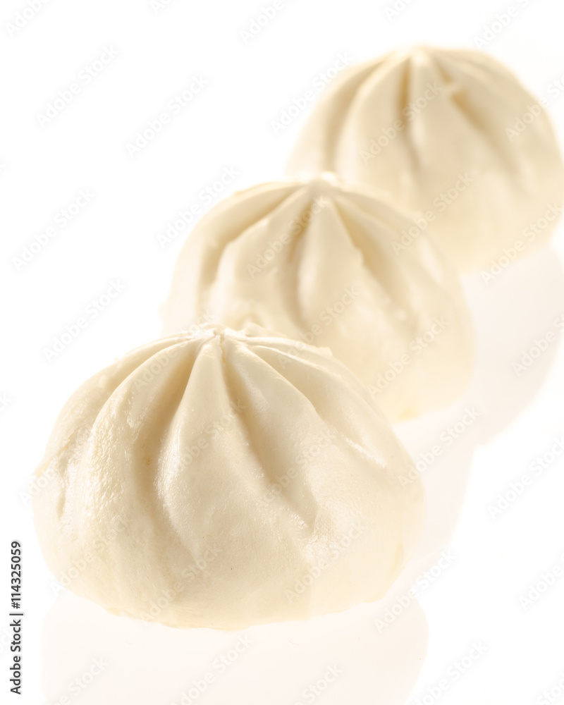 Chinese steamed buns isolated on white with light reflection