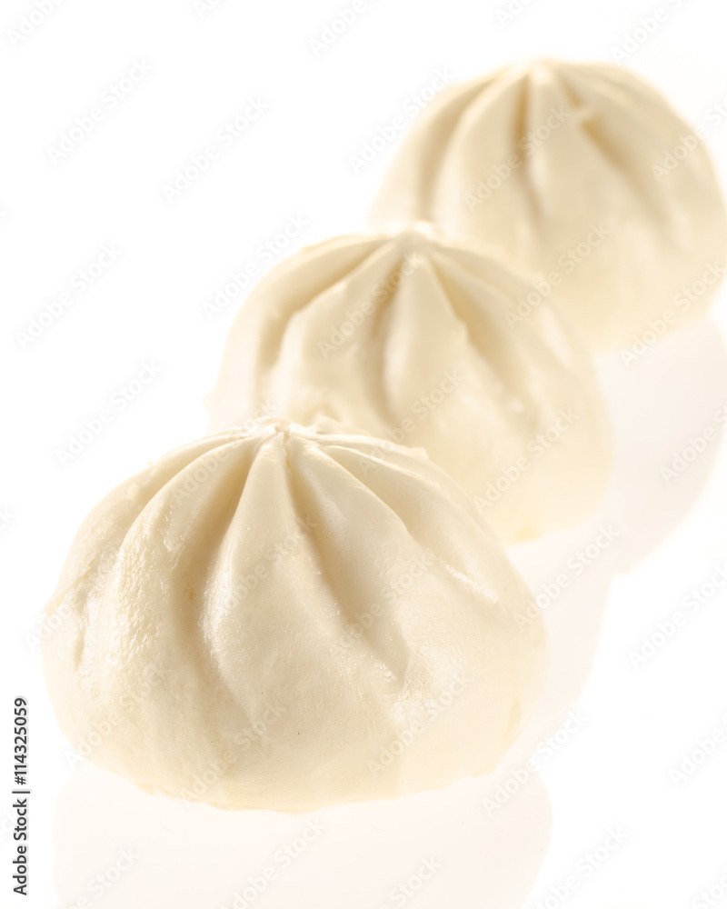 Chinese steamed buns isolated on white with light reflection Chinese steamed buns isolated on white with light reflection