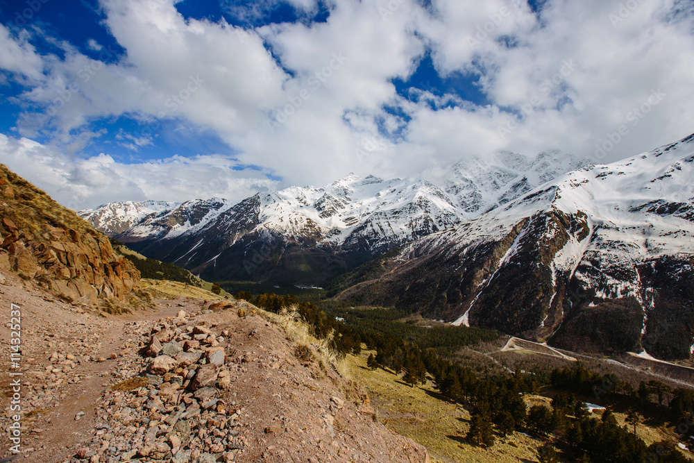 the mountain path on the background of snow-capped peaks the mountain path on the background of snow-capped peaks