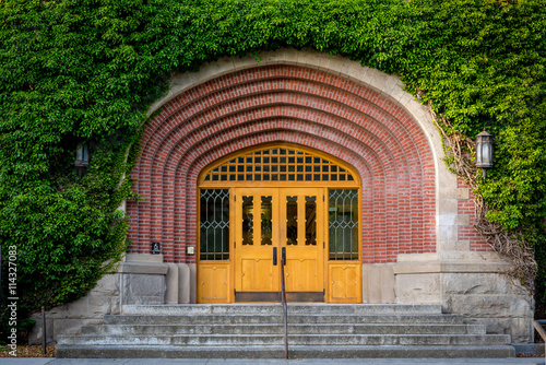 Building covered with ivy and front entry door