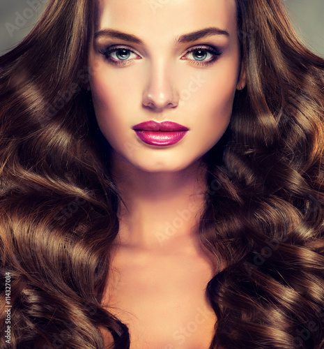 Fotografie Beautiful girl brunette  hair with an elegant hairstyle , hair wave ,curly hairstyle