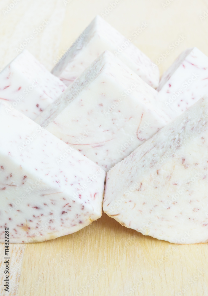 Taro sliced on wood plate prepare to cook Taro sliced on wood plate prepare to cook