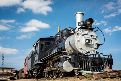 Old train engine from the west with blue sky and clouds