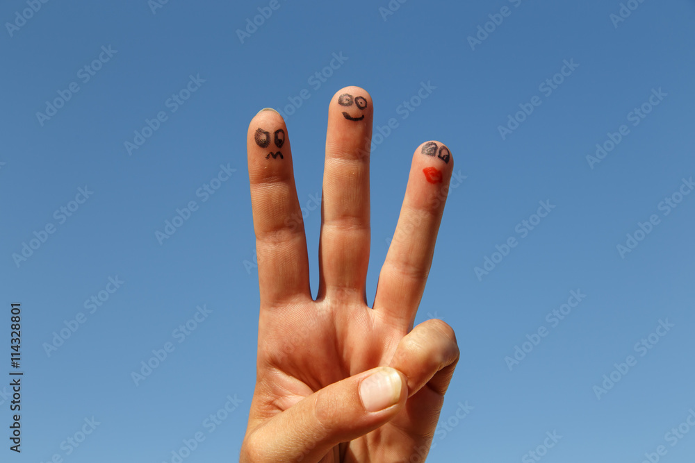 three painted fingers with sky at background three painted fingers with sky at background
