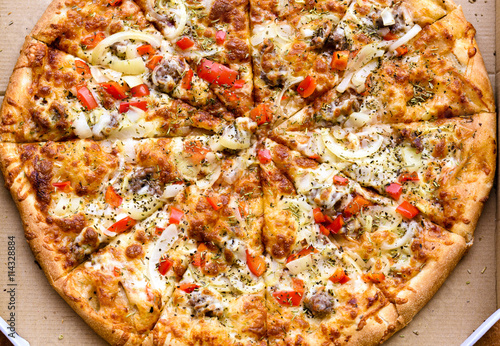 Italian pizza with sausage, red peppers and cheese mozzarella, onion, rosemary and basil