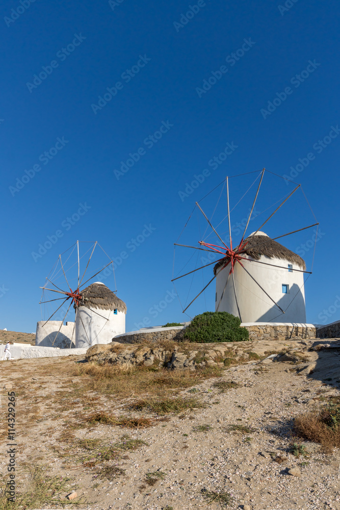 White windmill and Stone wall on the island of Mykonos, Cyclades, Greece