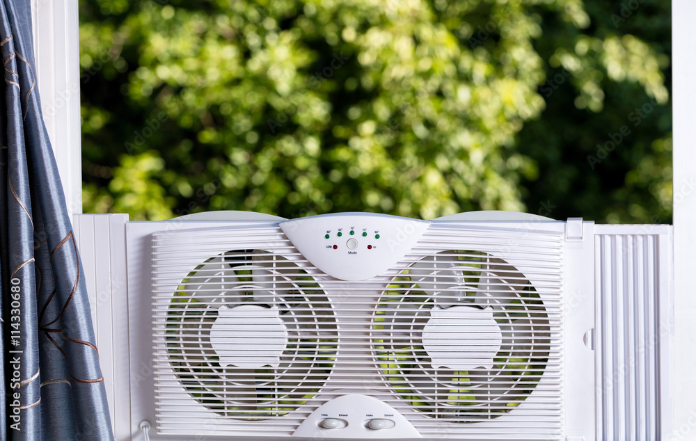 Window fan ready to cool down room in home during hot weather Stock