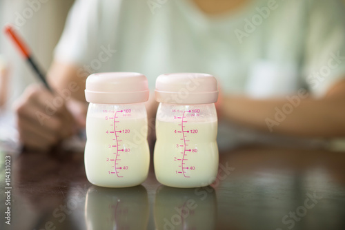 Mother writing breastfeeding stock for baby
