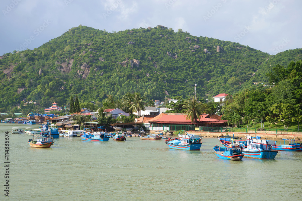 Waterfront Cai river in the vicinity of Nha Trang. Fishing boats moored near the shore. Vietnam
