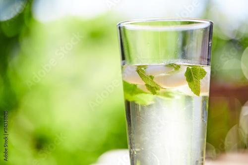 Cool drink with mint and ice on table