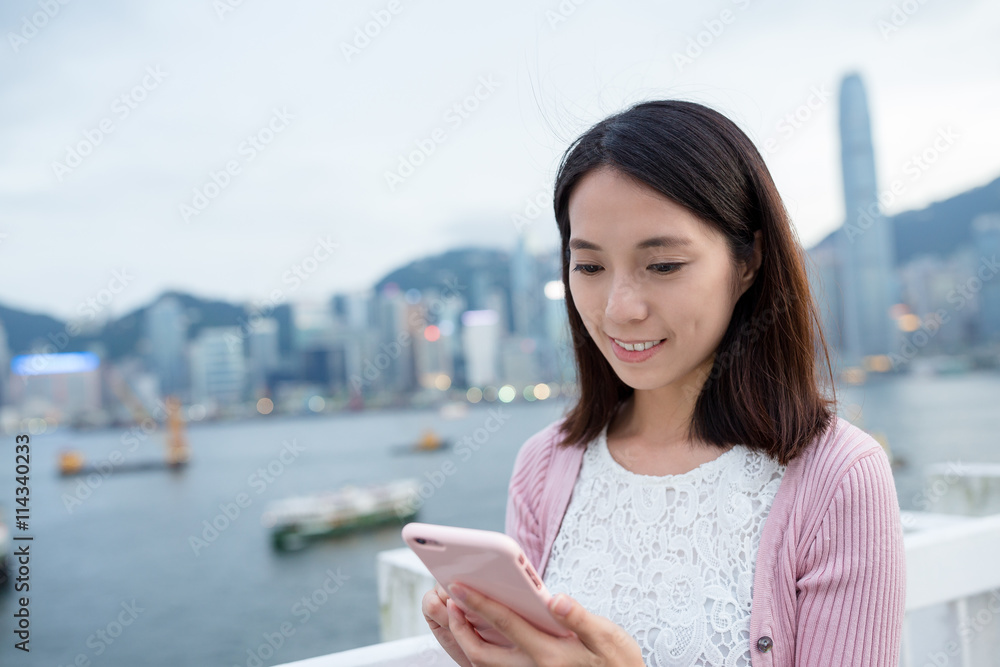 Fototapeta premium Woman use of mobile phone at Hong Kong