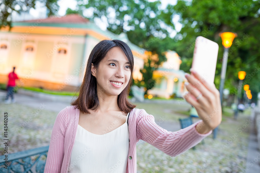 Woman take selfie by cellphone in Taipa house of Macau Woman take selfie by cellphone in Taipa house of Macau