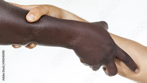Photos Interracial forearm shake,  helping , humanity and brotherhood concept