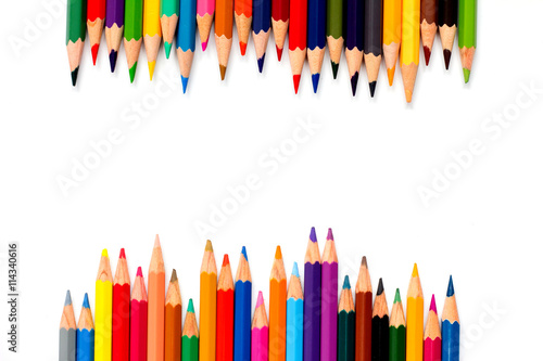 Row of color pencil placed on white background