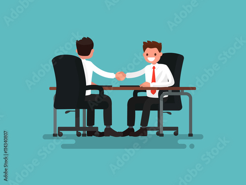 Business partners. Handshake of two businessmen behind a desk. V
