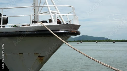 Tied down by Mooring Line. Closeup Bow of White Ship