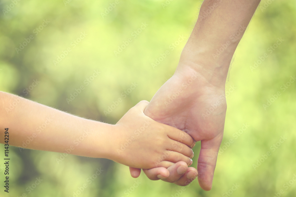 Father and daughter hands outdoors