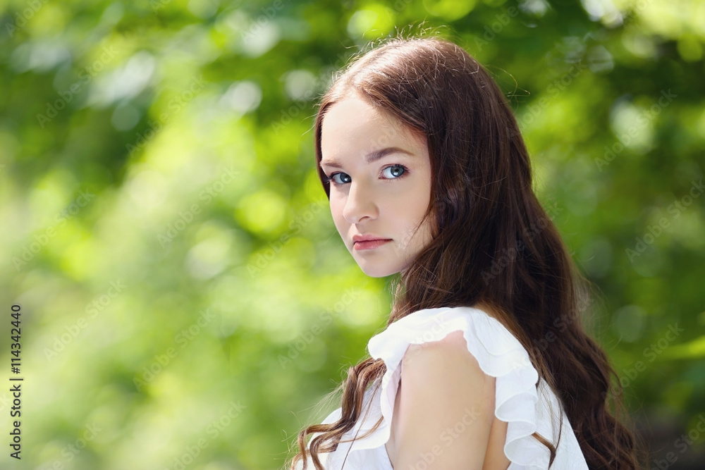 Beautiful girl relaxing in green park