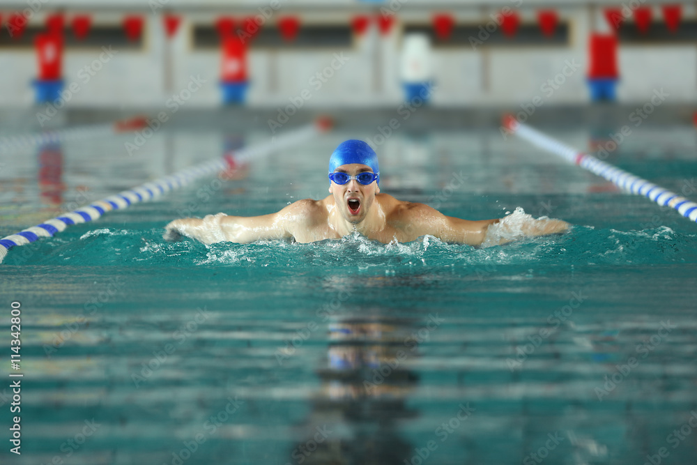 Sporty young man swimming in the pool