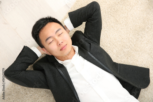 Handsome businessman lying ...
