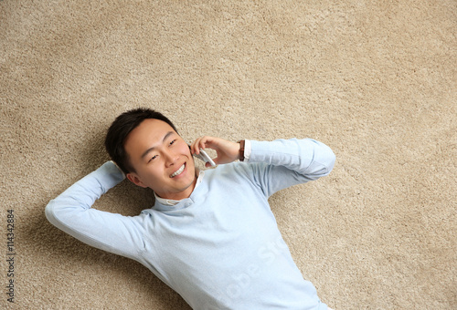 Handsome man lying on floor