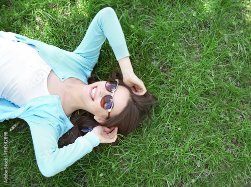 Beautiful girl lying on gre...
