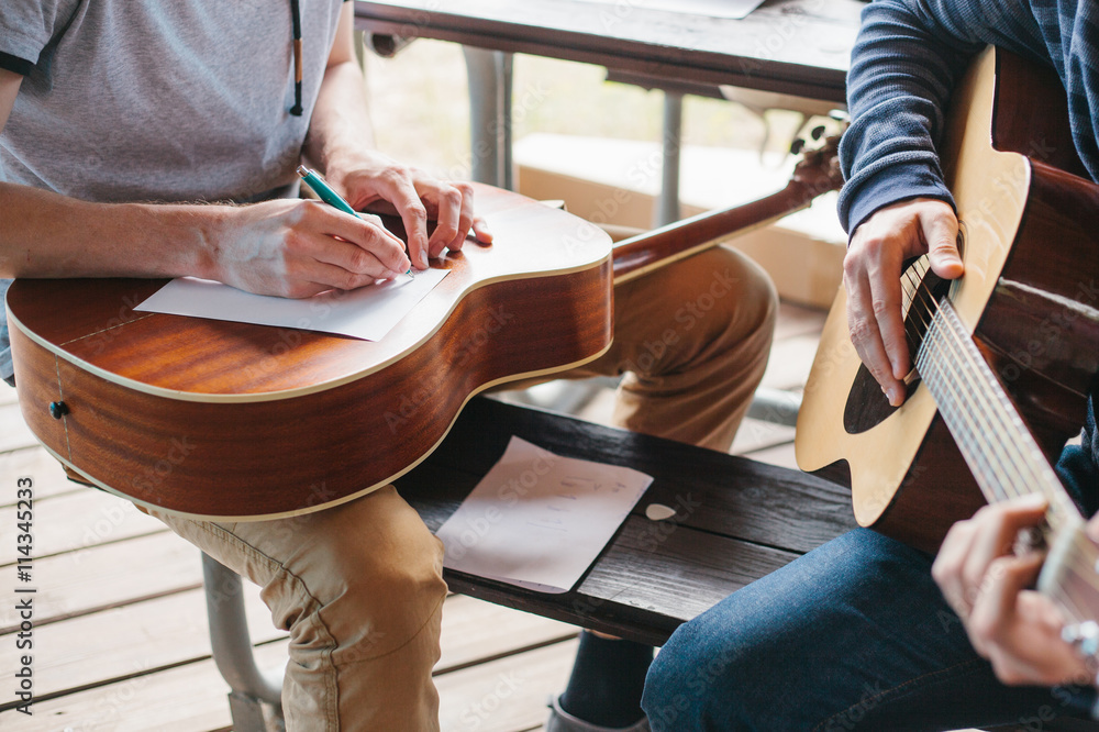 Obraz premium Learning to play the guitar. Music education and extra-curricular lessons.