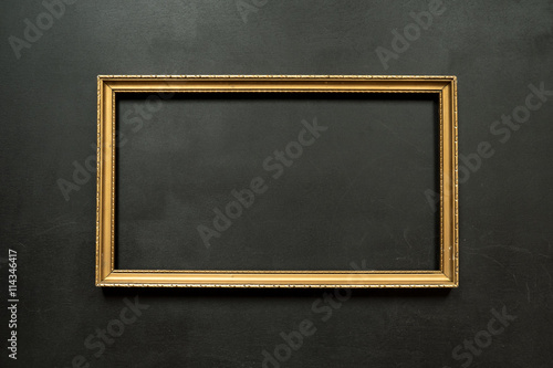 Plakat w ramie Horizontal gold thin picture frame on the black background with copy space