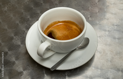 Cup of coffee on metal surface