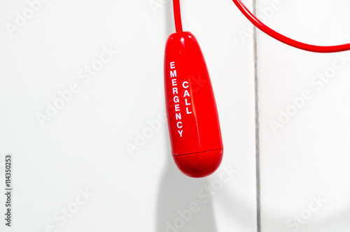 Red bathroom emergency pull cord in hospital
